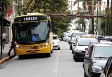 Avenida de Joinville com ônibus em parada junto ao fluxo de carros